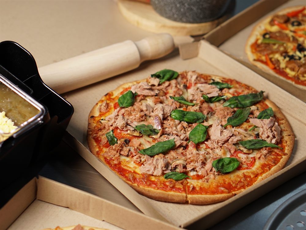 Tuna and basil pizza boxed on a busy pizza line, a menu application for Blue Bay Corned Tuna