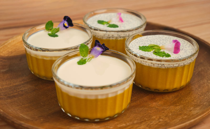 Mango sago pudding cups topped with sago and edible flowers, styled for food service dessert menus