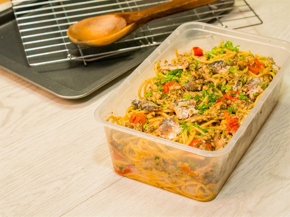 Sardine aglio olio batched in a food service tub with a baking tray and wooden spoon, a menu application for 555 Fried Sardines